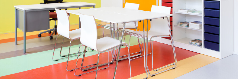 456,370 Royal Ahrend 456 seminar tables with chrome frame and white tops with 370 wireframe chairs in classroom front right view