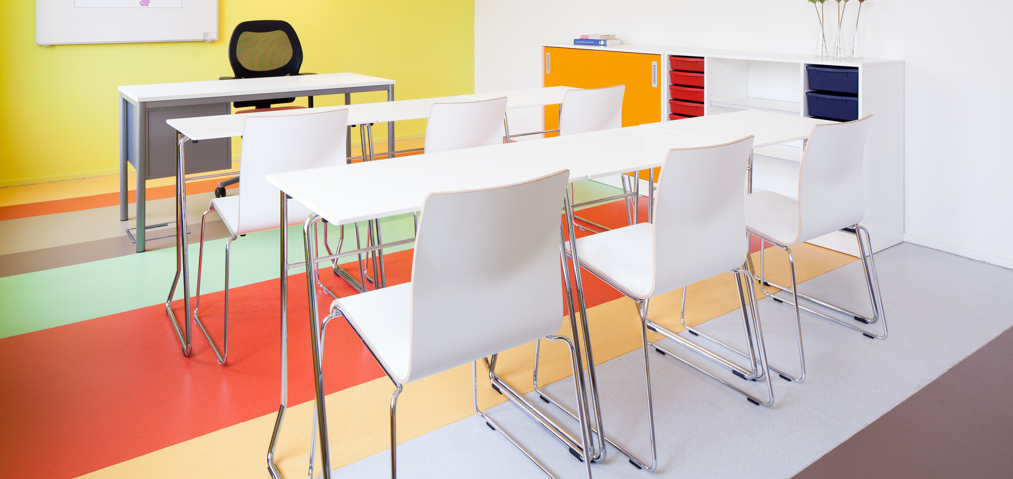 456,370 Royal Ahrend 456 seminar tables with chrome frame and white tops in 2 rows of 3 with 370 wireframe chairs in classroom rear left view