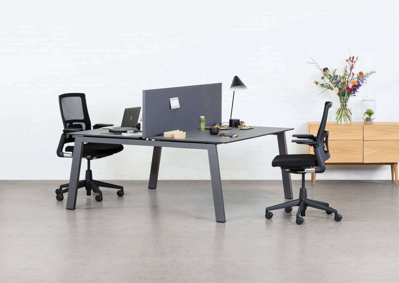 Balance, 2020 Verta Royal Ahrend Balance 4 leg dual workstation in anthracite with charcoal tops and grey screen with black 2020 office chairs front left view
