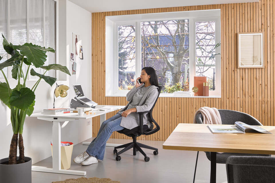 Home, Prime, Pyramid Table 02, Well Armchair Ahrend Home desk in white with black Prime office chair and Well armchairs with female mode in a work from home setting