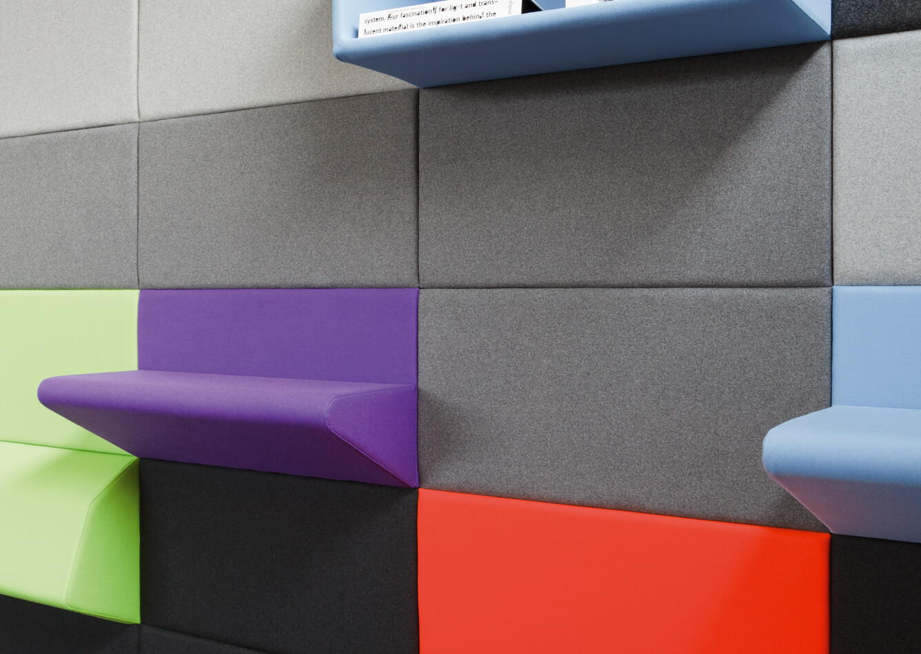 Living Wall Royal Ahrend Living Wall panels upholstered in grey with coloured seating and armrest panels with blue open cabinet front right view