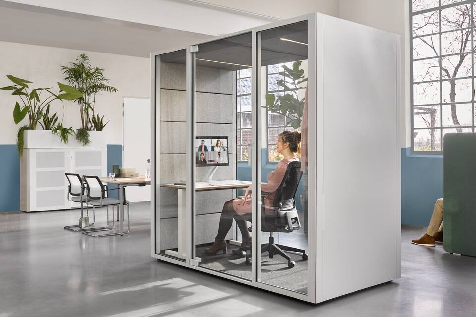 Qabin, Balance, Ease, Concentration Corner, Switch, Sliding door Cabinet, ZINN Ahrend Switch and Zinn with Qabin with Ease inside and door closed with SDK with planter in the back with models in a Hybrid working community setting