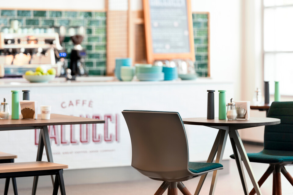 Well, Pyramid Royal Ahrend Well trestle wood base chairs with grey shells and green front upholstered at Caffe Dallucci in Amsterdam DSF3291