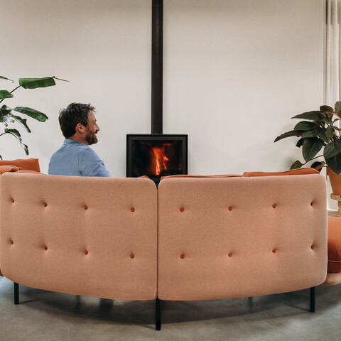 Embrace Royal Ahrend Embrace sofa upholstered in red and yellow with female and male model at HofmanDurjandin office in Diemen EB011