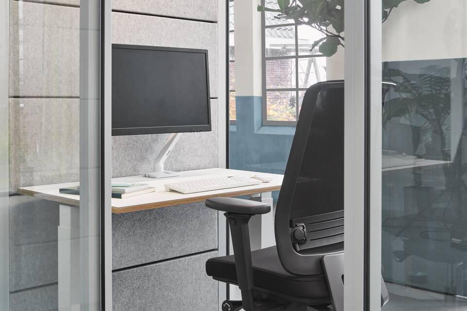 Qabin, Balance, Ease Ahrend inside of Qabin with Ease office chair and desk in a Hybrid working community setting