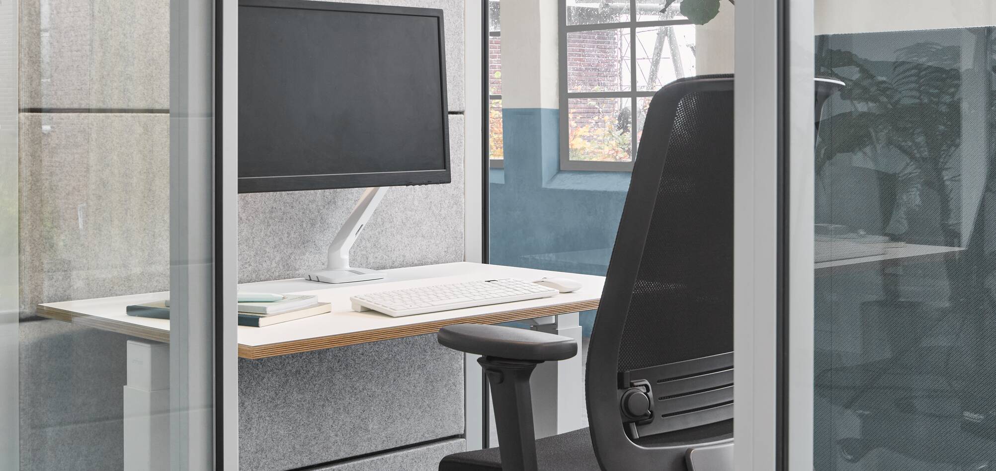 Qabin, Balance, Ease Ahrend inside of Qabin with Ease office chair and desk in a Hybrid working community setting