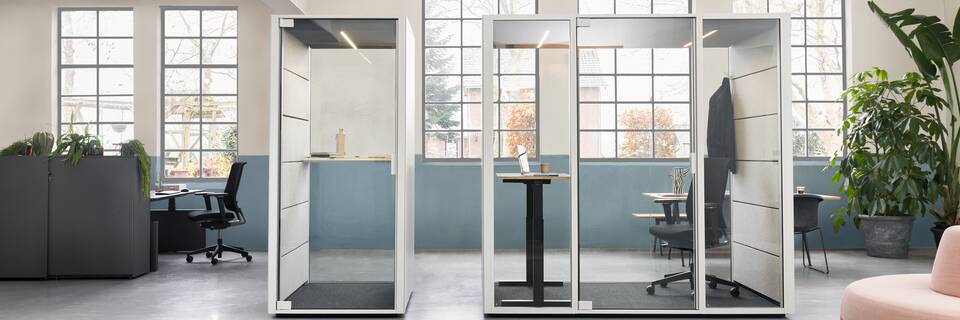 Qabin, Sliding Door Cabinet, Balance, Ease, Recharge 165, Pyramid, Well Ahrend Qabin booth and space in space with Ease office chair and black stand desk with Balance SDK Recharge and Well in a Hybrid working community setting