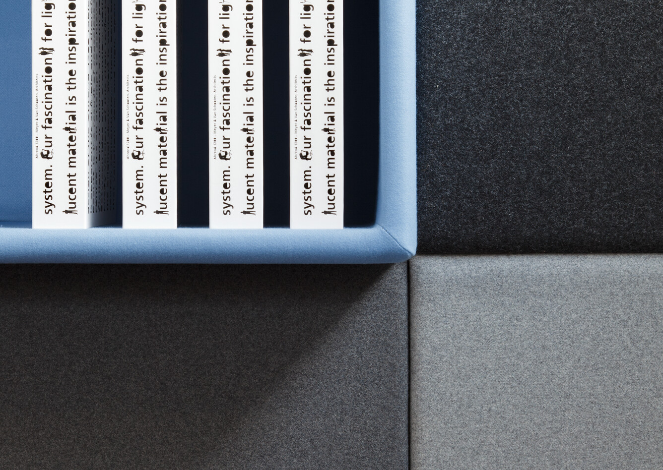 Living Wall Royal Ahrend Living Wall panels upholstered in grey with blue open cabinet front view