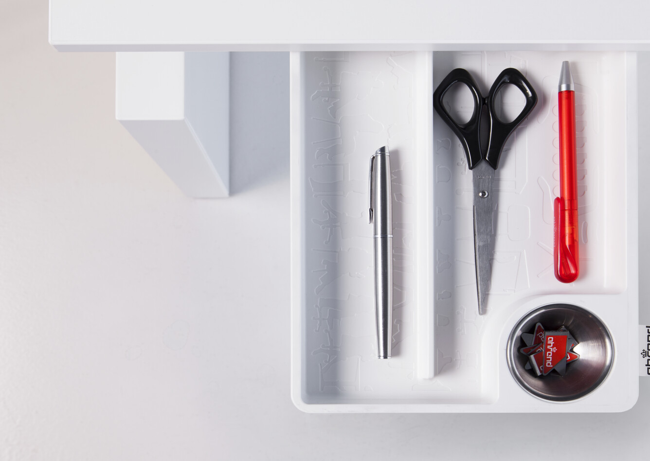 Clean Royal Ahrend Clean desk tray in white fully retracted from under tabletop filled with utensil top view