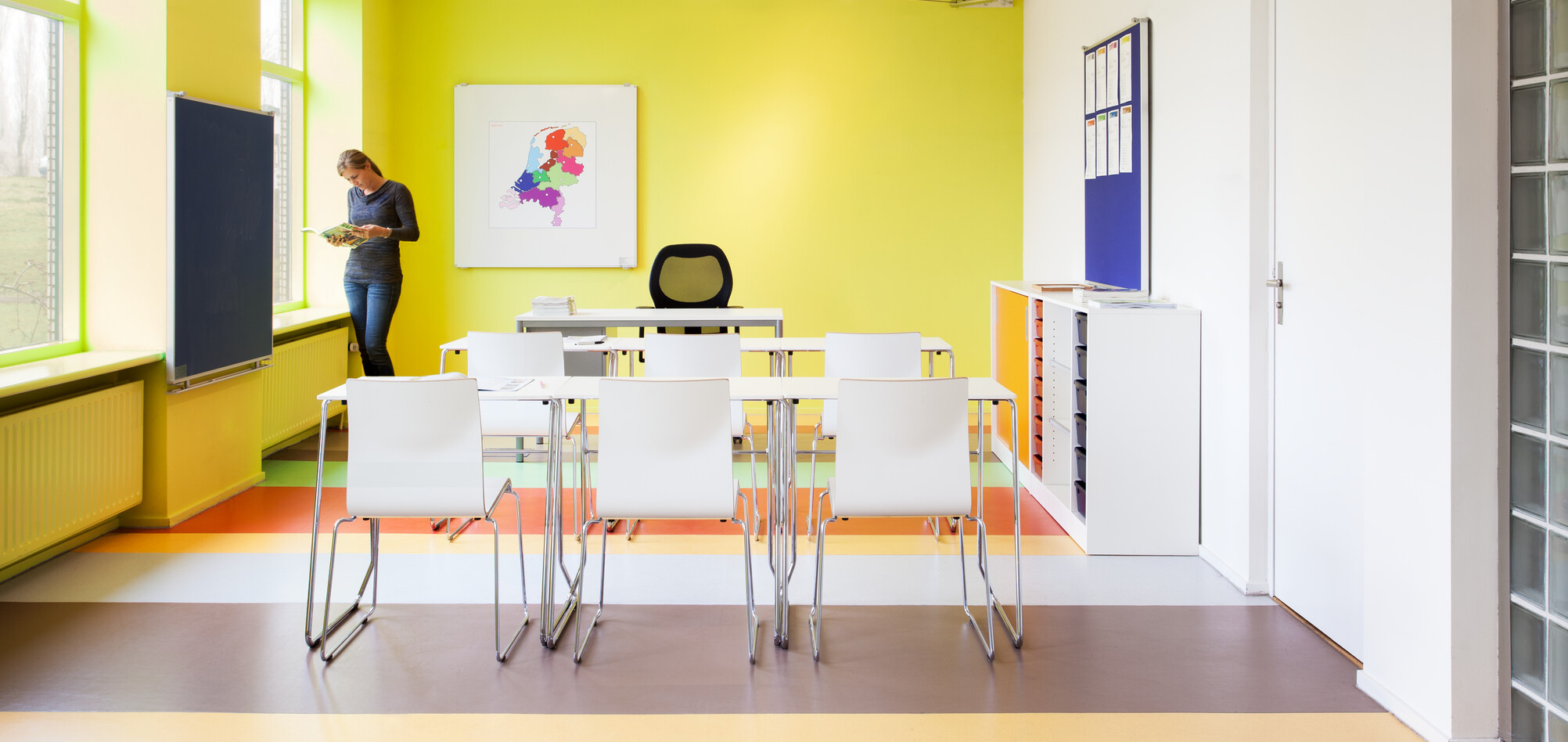 456,370 Royal Ahrend 456 seminar tables with chrome frame and white tops in 2 rows of 3 with 370 wireframe chairs in classroom rear view
